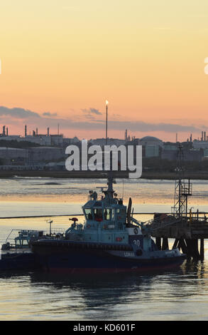a tug on station or standby at the marine terminal at the esso or exon mobil oil refinery at fawley near the port of Southampton in Hampshire , uk Stock Photo