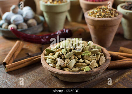 Most expensive spice in the world – dried green cardamom pods with black seeds, used as an ingredient in many cuisines and for medical use close up Stock Photo