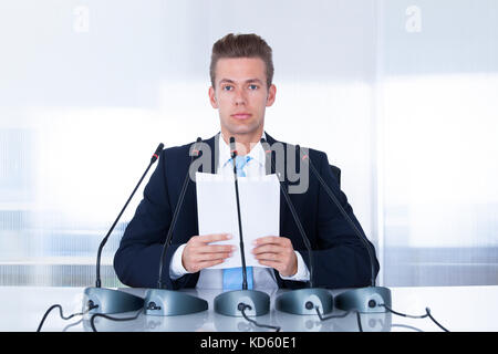 Young Businessman Giving Speech In The Conference Stock Photo