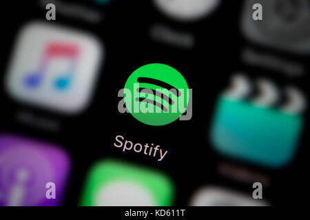 A close-up shot of the company logo representing the Spotify app icon, as seen on the screen of a smart phone (Editorial use only) Stock Photo