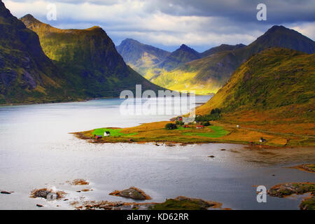 Sunny Lofoten day. Beautiful fjord in autumn day. Colorful rocks and blue water of Norway. Stock Photo