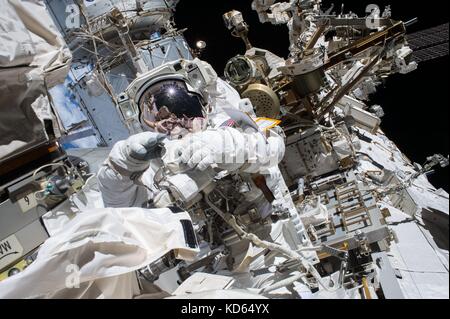 International Space Station Expedition 53 crew member Mark Vande Hei during a spacewalk to install a new latching end effector on the tip of the Canadarm2 robotic arm October 6, 2017 in Earth Orbit. The Bresnik and Mark Vande Hei worked for 6 hours, 55 minutes to replace the part during the first spacewalk of their expedition. Stock Photo
