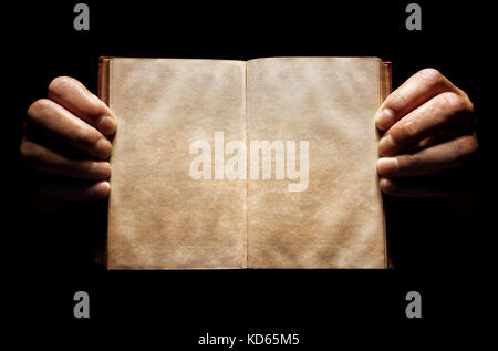 Hands holding an open empty book background in the dark with copy space Stock Photo