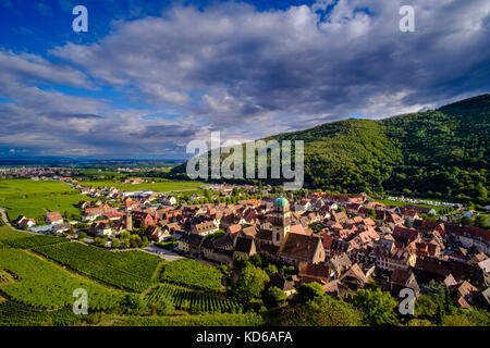 Aerial panoramic view on the small town, surrounded by vineyards, located at the foot of Alsace hills Stock Photo