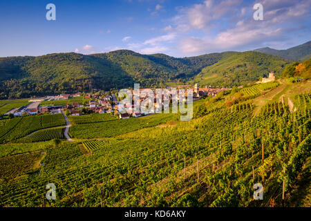 Aerial panoramic view on the small town, surrounded by vineyards, located at the foot of Alsace hills Stock Photo