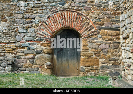 Red Roman bricks incorporated into a Saxon doorway, All Saints' Church, Brixworth, Northamptonshire. Stock Photo