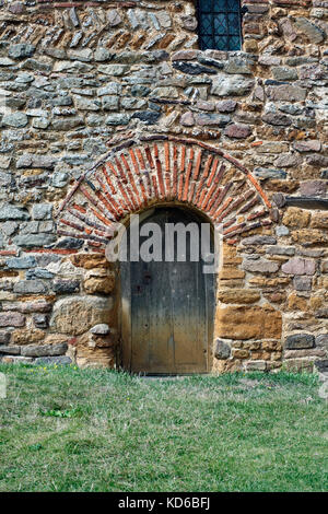 Red Roman bricks incorporated into a Saxon doorway, All Saints' Church, Brixworth, Northamptonshire. Stock Photo