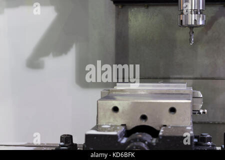 CNC machining Center machine cutting part with coolant, milling machine Stock Photo