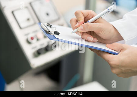 Hands of woman engineer ready for writing technical report about Stock Photo