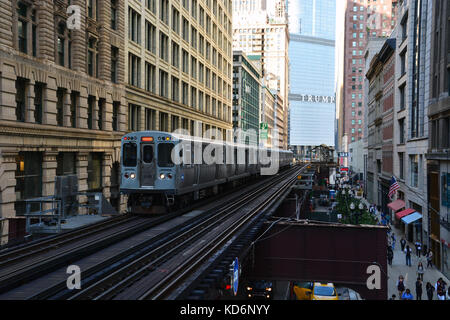 A south bound Orange Line CTA train arrives at the Washington & Wabash station platform in downtown Chicago. Stock Photo