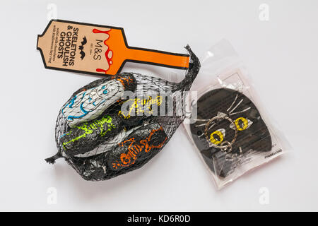 M&S Skeletons & ghoulish ghosts solid milk chocolates with Halloween key ring ready for Halloween isolated on white background Stock Photo
