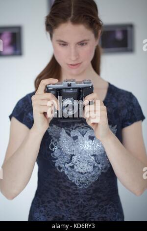 Woman with Zeiss camera Stock Photo