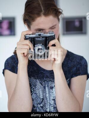 Woman with Zeiss camera Stock Photo