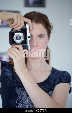 Woman with Zeiss camera Stock Photo
