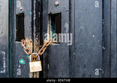 Chained and padlocked black gate with copy space, ideal book cover. Stock Photo