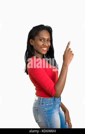 Woman pointing up side view Stock Photo