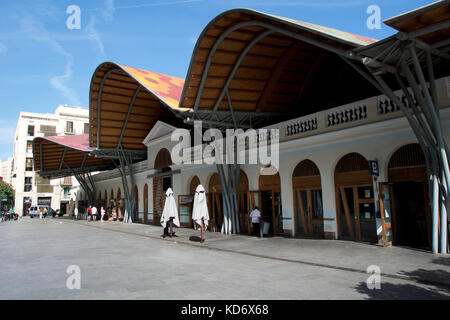 BARCELONA, SPAIN - AUG 30th, 2017: Front side of the public market Mercat de Santa Caterina. Guests have lunch in the Tapas bar. The market has a nice colorful curved roof Stock Photo