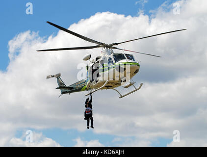 Miami, Florida - march 2, 2008: Miami Dade County police helicopter conducts emergency airlift training. The county police department has a fleet of a Stock Photo