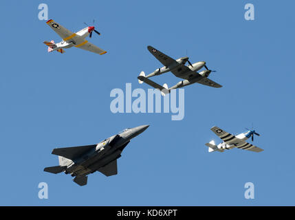 Houston, USA - November 1, 2009: Two generations of US fighter planes perform a fly by. Participating as a modern F-15 together with World War II P-51 Stock Photo