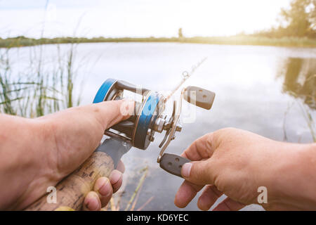 Man Is Fishing With A Backcasting Reel Stock Photo - Download Image Now -  Fishing Industry, Fishing, Competition - iStock