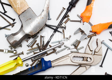 Construction tools with random nails, pins, screws isolated on white background Stock Photo