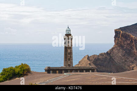 Old  lighthouse Capelinhos on the shore of Atlantic ocean, the Azores Stock Photo