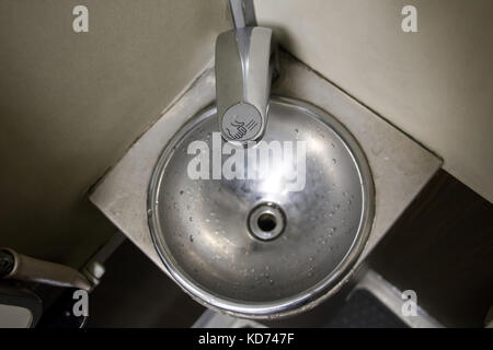 stainless steel sink in the corner of the bathroom on the train. Public toilets on the train. Stock Photo