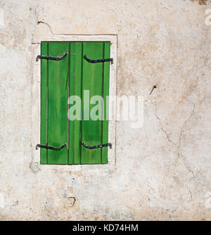 Green shuttered window on an old village house on the island of Ithaka in the Ionian Islands Greece Stock Photo