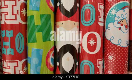 Wrapping paper rolls for Christmas gifts on brown wooden board Stock Photo  by ©Fotofabrika 408685368