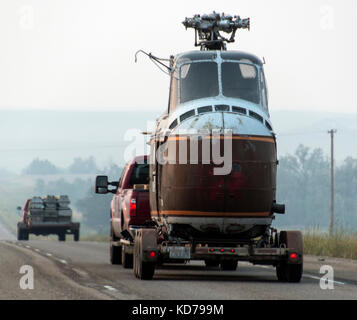 An old helicopter being transported on a trailer in North Dakota. Stock Photo