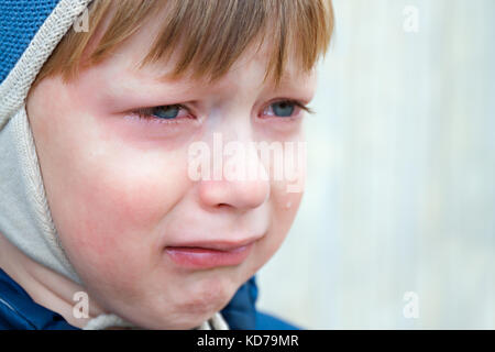 little boy was crying from hurt, tears stream down cheeks. emotion child sadness. kid cry Stock Photo