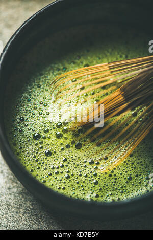 Flat-lay of freshly brewed Japanese matcha green tea, vertical composition Stock Photo