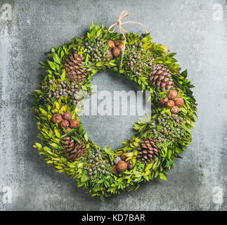Christmas decorative wreath over concrete wall background Stock Photo