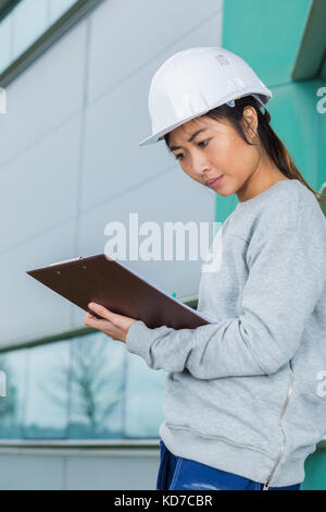 female construction manager with her helmet and her tablet Stock Photo