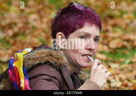 Westminster. London, UK. 10th October, 2017. A woman smokes cannabis during the tea party. The protest organised by United Patients Alliance (UPA) inviting members of the public to consume tea and cakes containing cannabis outside Houses of Parliament in a bid to legalise the drug for medicinal purposes as Labour MP Paul Flynn raises a Private Member's Bill bidding to change the law. Credit: Dinendra Haria/Alamy Live News Stock Photo
