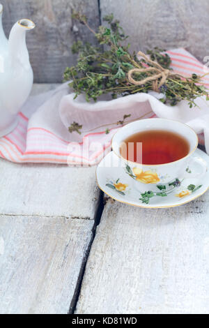 Herbal tea with thyme on rustic background Stock Photo