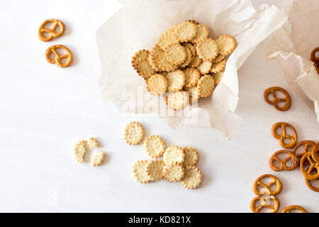 Pretzels and crackers on wooden table from above Stock Photo