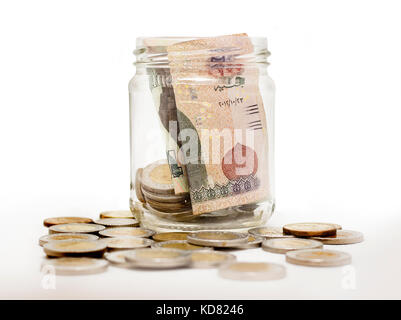 Egyptian Pounds, Coins and Banknotes in Glass Jar, Isolated on White Background Stock Photo