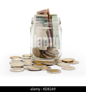 Egyptian Pounds, Coins and banknotes in Glass Jar, Isolated on White Background Stock Photo