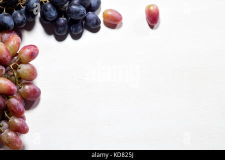 trendy fruit set on a blue background, mini bananas, limes, oranges, lined frame, space for text, top view Stock Photo