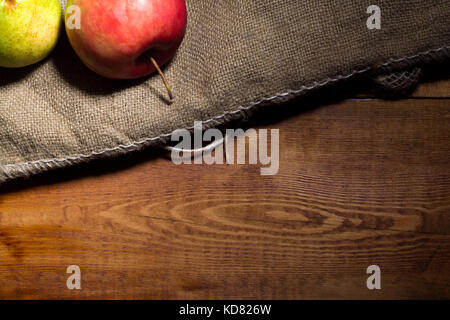 Red apples on a wooden background with sacking Stock Photo