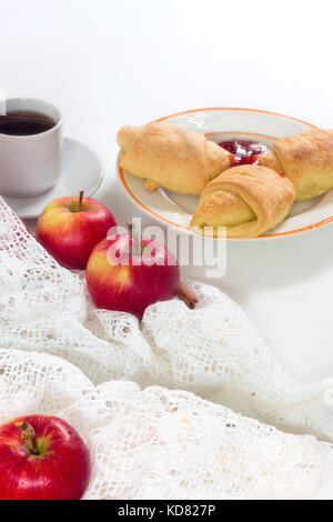 Breakfast table with croissants, fresh fruit on white background Stock Photo