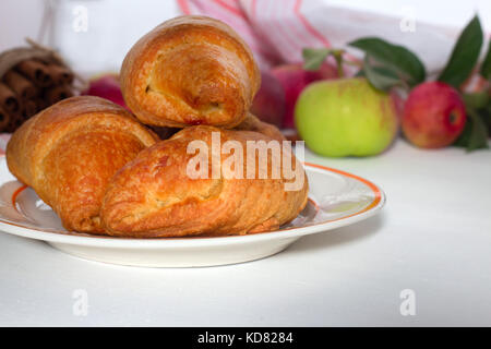 healthy breakfast croissants , apple on white wooden background Stock Photo