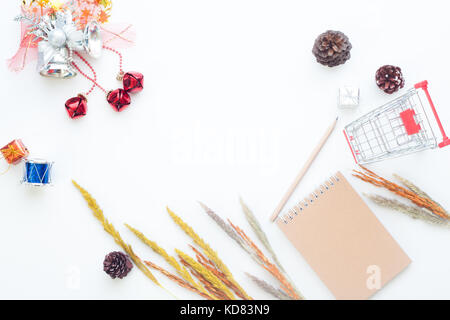 Flat lay Christmas and winter items with shopping cart on white background, Online shopping in winter Stock Photo