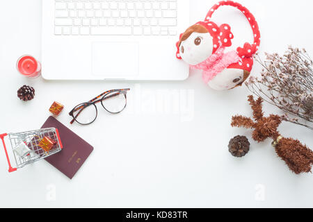 Creative flat lay of Christmas and holiday concept with notebook and Christmas decorations on white background Stock Photo