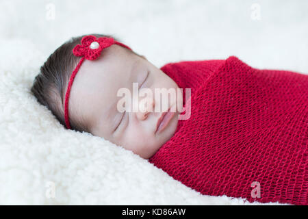 Baby girl wrapped in a blanket sleeping Stock Photo