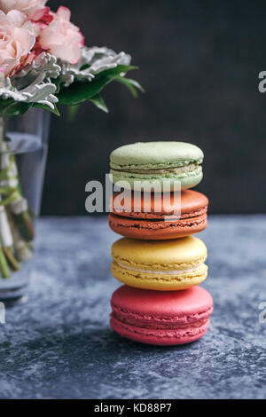Stack of colorful macarons on grey background Stock Photo