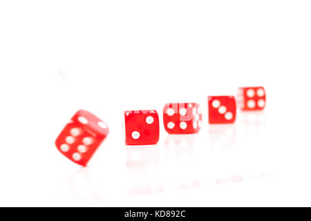 Red Casino Dices in a Row on White Background With Some Movement Stock Photo
