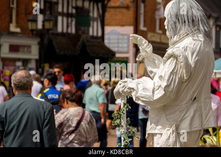 Street Artist / Living Statue performing as the Ghost of William Shakespeare for passing tourists, Henley Street, Stratford-upon-Avon, England, U.K. Stock Photo