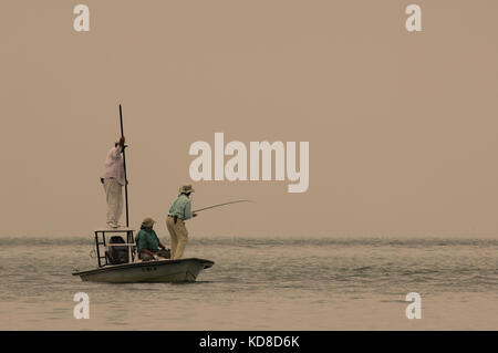 A fisherman lands a tarpon caught while fly fishing the Florida Keys near Key West Stock Photo